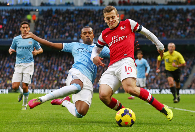 Football - Manchester City v Arsenal - Barclays Premier League - Etihad Stadium - 14/12/13 Manchester City's Fernandinho (L) in action with Arsenal's Jack Wilshere Mandatory Credit: Action Images / Jason Cairnduff Livepic EDITORIAL USE ONLY. No use with unauthorized audio, video, data, fixture lists, club/league logos or live services. Online in-match use limited to 45 images, no video emulation. No use in betting, games or single club/league/player publications. Please contact your account representative for further details.