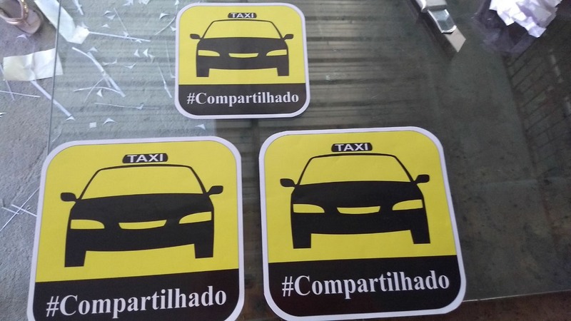 Adesivo identifica o serviço nos táxis que oferecem corridas compartilhadas em Manaus (Foto Divulgação)