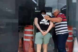 Momento em que um dos suspeitos de furto de veículos chegou à delegacia (Foto: Divulgação/PC-AM)