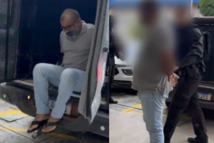 Um dos suspeitos no momento que chegava à delegacia: prática de extorsão (Foto: Reprodução/WhatsApp)